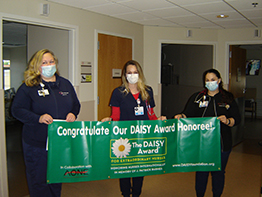 Teri Dagnesi, RN (center) is congratulated by Melissa Grummons, RN, 2 West Nurse Manager and Leann Alfonso, RN.