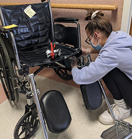 student fixing wheelchair