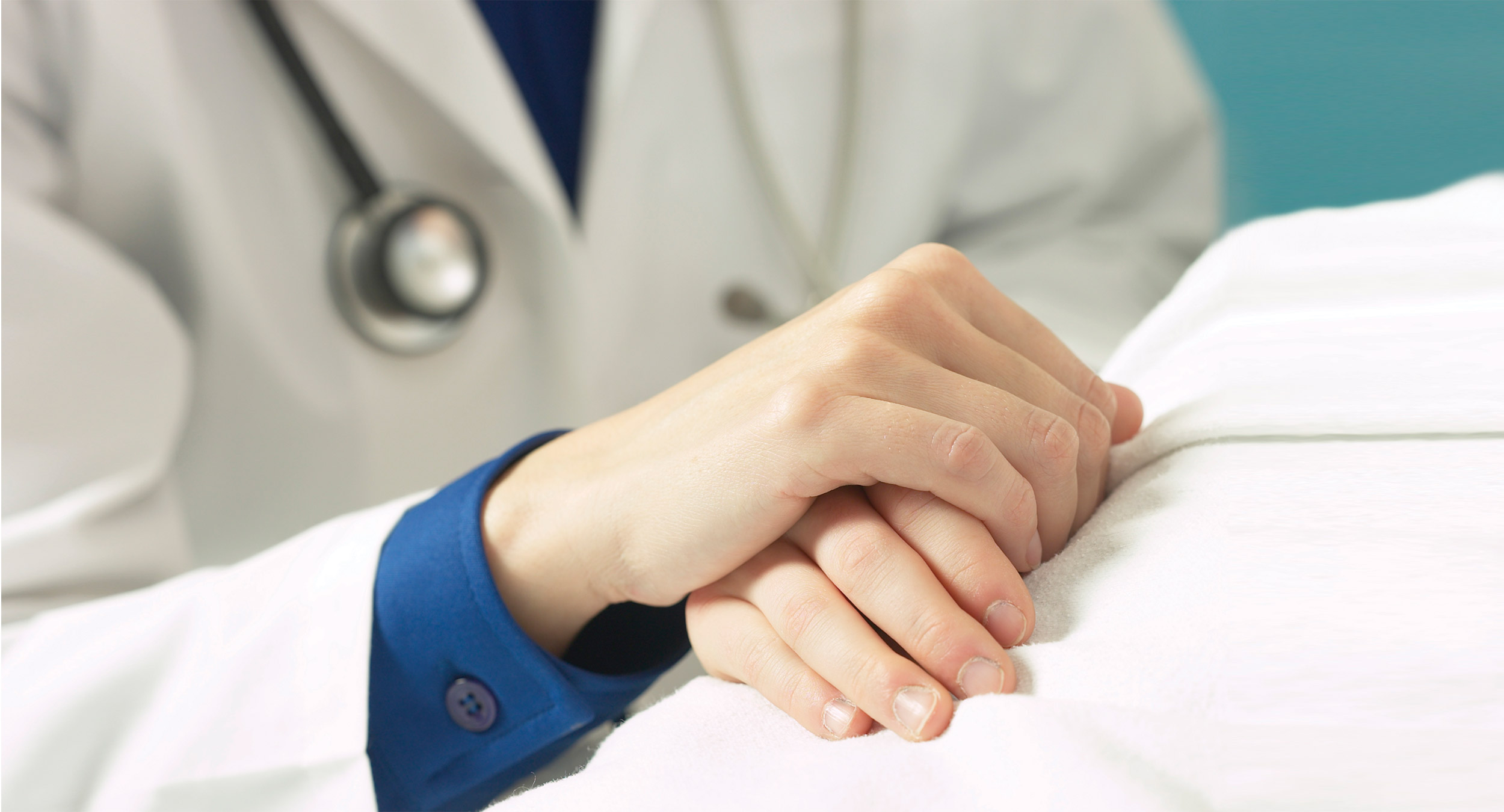 Doctor holding patient hand